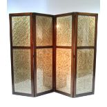 An Edwardian mahogany four-fold draught screen inset silk needlework glazed panels; 79" wide x