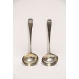 A pair of George III Old English sauce ladles with oval bowls; London 1805, by Thomas Wallis II. (