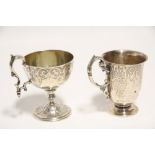 A Victorian hemispherical cup with renaissance-style engraved border, cast scroll handle, on