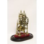 A 19th century brass skeleton timepiece of typical spire design, with 4" pierced silvered chapter