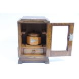 An oak pipe-smoker’s cabinet fitted treen mixing bowl & enclosed by glazed door, 8¾” wide x 12¾”