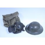 A WWII American steel safety helmet; a British steel safety helmet; & a British respirator.