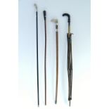 Three vintage walking canes; & a vintage umbrella (w.a.f.).