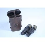 A pair of British WWI black lacquered brass binoculars by Bisleys, with leather case.