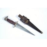 An eastern dagger with 7¾” long double-edge tapered blade, cast-metal grip, & with leather sheath.