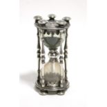 A CONTINENTAL SAND GLASS with circular ring-turned end plates & five slender baluster supports,