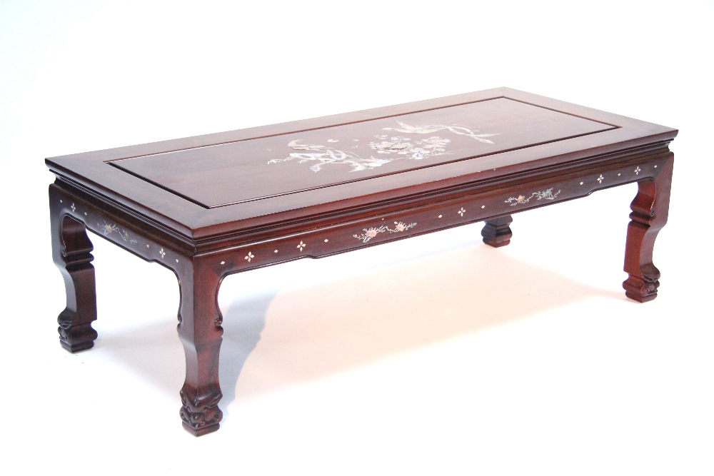 A Chinese hardwood low rectangular occasional table, matching the preceding lot; 50" x 22".