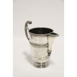 AN EARLY 18th century CONTINENTAL HELMET-SHAPED JUG with trefoil support below the narrow spout,