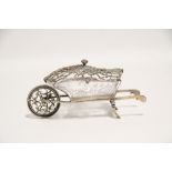 An Edwardian posy holder (?) in the form of a wheelbarrow, with finely cut glass trough held in