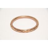 A 9ct. gold plain circular hollow bangle. (18.2 gm).