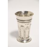 An Edwardian beaker of flared form & with planished surfaces, the lower part semi-fluted, with