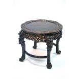 A late 19th century Chinese hardwood circular occasional table with lobed border & all-over carved