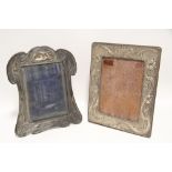 An Edwardian Art Nouveau style rectangular photograph frame with embossed stylised floral borders,