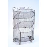 A galvanised wire mesh three-tier vegetable rack with small enamel sign inscribed: "For Keeping