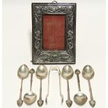 A set of six Edwardian teaspoons & matching sugar tongs with Art Nouveau stylised terminals,