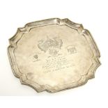 A square salver with re-entrant corners & raised moulded border, the centre with engraved
