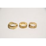 Two 18ct. gold belt design rings; & an 18ct. gold floral engraved band. (17.3 gm total).