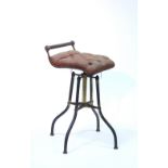 A Victorian adjustable music seat with oxidised brass frame & padded buttoned top. (worn).