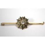 A 15ct. gold bar brooch with roundel set cushion-shaped diamond of approx. 0.3 carats to the centre,