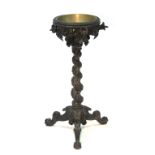 A mid-19th century Anglo-Indian carved teak jardinière stand with brass circular liner, the