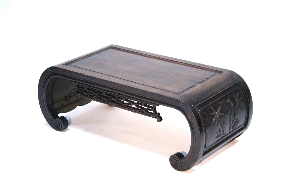 A Chinese hardwood rectangular low occasional table with pierced frieze to both sides, the scroll