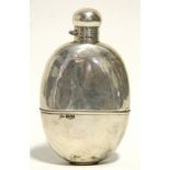 A late Victorian oval pocket spirit flask with ball-shaped hinged screw cap, 5¾" high; the body with