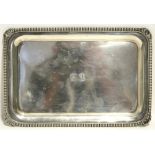 A late Victorian small rectangular tray with gadrooned rim & engraved family crests to the centre,