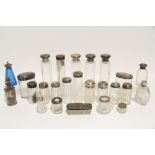 Twenty one various silver-lidded glass toilet case receptacles; & various other silver-mounted glass