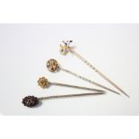 Three 15ct gold stick pins (two of which set small gemstones), & another stick pin with enamel