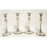 A SET OF FOUR LATE VICTORIAN/EDWARDIAN CANDLESTICKS in the late 18th century style, with