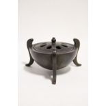 A CHINESE BRONZE CENSER of hemispherical form, with slightly domed pierced lid, & on three curved