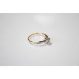 An 18ct gold ring set single diamond weighing approx. 0.3carat, with smaller stones to the