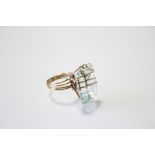 AN AQUAMARINE RING, the large emerald-cut stone measuring approx. 21mm x 15mm, set to an un-marked