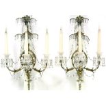 A PAIR OF GEORGE III STYLE ORMOLU WALL LIGHTS, each with oval mirror back-plate with segmented