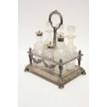 A late 19th/early 20th century rectangular cruet stand with centre ring handle, fitted six cut-glass