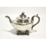 An early Victorian ‘Batchelor’ teapot of compressed round form, with cast fruit-pod finial to the