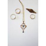 An early 20th century 9ct. gold openwork pendant set two sapphires, on gilt-metal chain necklet; a