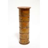 A 19th century treen spice tower of six cylindrical compartments, each with printed paper label, the