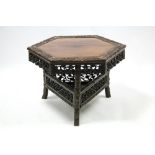 A Chinese hardwood hexagonal low occasional table with carved floral border, carved & pierced floral