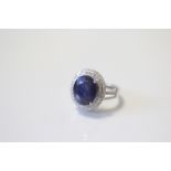 A SAPPHIRE & DIAMOND RING, the oval-cut sapphire measuring approx. 13mm x 11mm, set within a