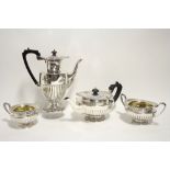 A LATE VICTORIAN FOUR-PIECE TEA & COFFEE SERVICE of squat round semi-fluted design, the coffee pot
