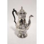 An 18th century style baluster-shaped coffee pot with embossed floral decoration & gadrooned rims,