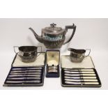 An oval semi-fluted three piece tea service; a set of six tea knives with loaded silver handles;