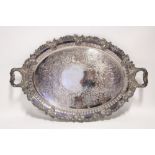 An oval two-handled tray with chased floral & leaf-scroll decoration & gadrooned rim, 25" x