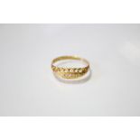 An 18ct gold ring set row of five small graduated diamonds; Chester 1920.