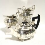 A Regency-style three piece tea service of compressed semi-fluted oblong form, each on four ball