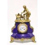 A 19th century French mantel clock in deep blue ground porcelain case all-over decorated with