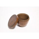 A 19th century pear-wood box of ovoid shape, with flat screw cover; 3¼” diam. x 2½” high. (Slight