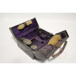 A George V morocco leather grooming case, 8” wide, part fitted with eight silver-mounted items,
