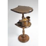 A walnut two-tier pipe smoker’s table with horse-shoe shaped tiers, and on turned centre column & on